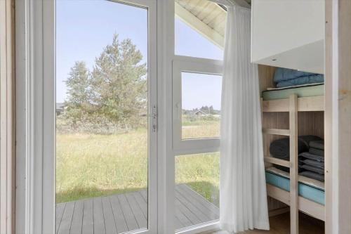 a sliding glass door with a view of a field at LN1959-Hirtshals-Tangen-3 in Hirtshals