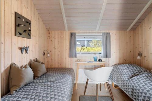 a bedroom with a bed and a desk and a window at SJ285-Bjert-Kystvej-64-A in Åbjerg