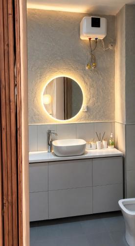 a bathroom with a sink and a mirror at D'Empire in Lekki