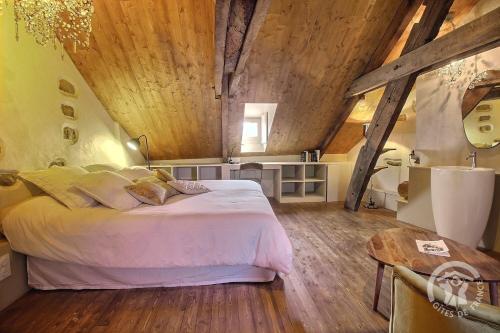 a bedroom with a large bed and a wooden ceiling at Hôtel des ducs de bretagne in Saint-Brieuc