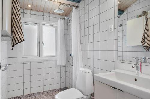 a white bathroom with a toilet and a sink at SJ291-Hejls-Brombaervaenget-36 in Hejls