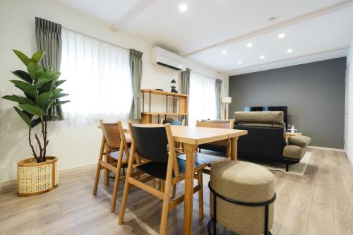 a living room with a wooden table and chairs at Crescout Toa 1 in Gotemba