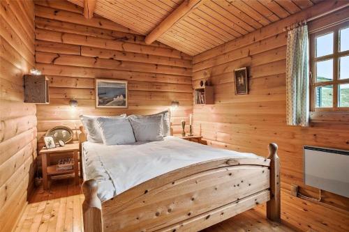 a bedroom with a bed in a log cabin at LN1500-Hirtshals-Kranken-11 in Hirtshals