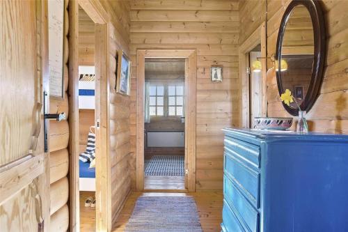 a bathroom with a blue cabinet in a wooden room at LN1500-Hirtshals-Kranken-11 in Hirtshals