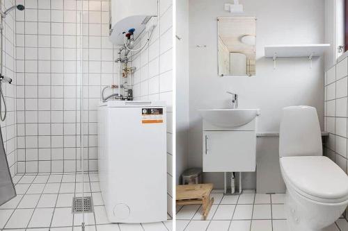 a white bathroom with a toilet and a sink at SJ299-Hejlsminde-Poppelvaenget-4 in Hejlsminde