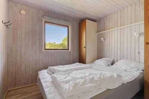 a large bed in a room with a window at SJ299-Hejlsminde-Poppelvaenget-4 in Hejlsminde