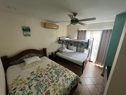 a bedroom with a bed and a crib at Tropical Stay in Coco in Coco