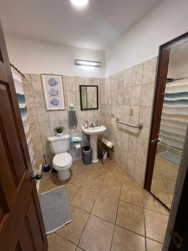a bathroom with a toilet and a sink at Tropical Stay in Coco in Coco