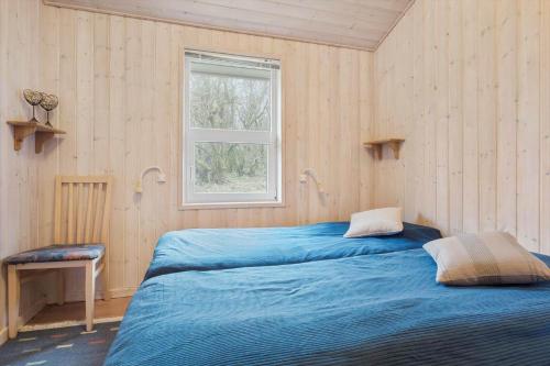 a bedroom with two beds and a window at LN1971-Lonstrup-Kirkedalsvej-7 in Lønstrup