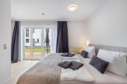 a bedroom with a large bed with pillows on it at Terrasse Double Studio Apartments in Lübeck