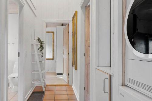 a hallway with a bathroom with a toilet and a television at SJ311-Hejls-Slaenvaenget-9 in Hejls