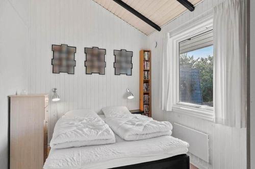a white bedroom with a bed and a window at SJ311-Hejls-Slaenvaenget-9 in Hejls