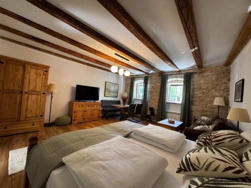 a bedroom with two beds and a living room at Ferienwohnung Strohblume 2 in Rust