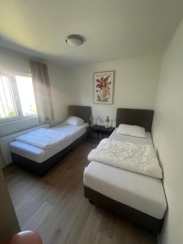 two beds in a room with two beds sidx sidx sidx sidx at Green Flower in Renesse