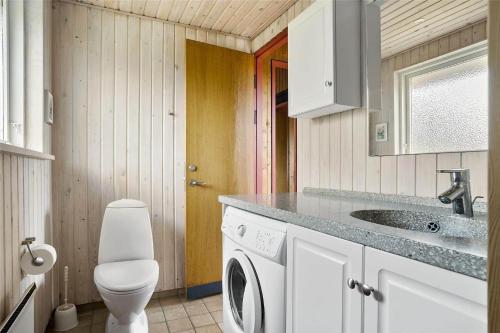 a bathroom with a sink and a washing machine at LN76740-Hjorring-Sostjernevej-11 in Hjørring