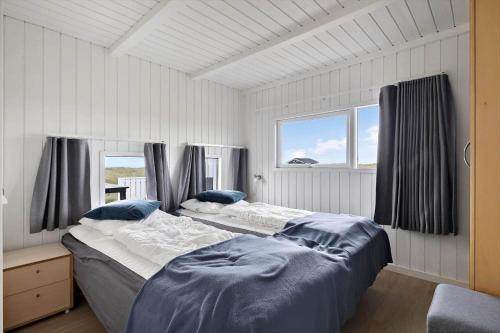 a bedroom with two beds and two windows at LN1802-Hjorring-Bovlingbjergvej-4 in Hjørring
