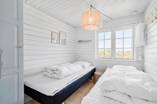 a bedroom with two beds and a window at LN1883-Hjorring-Revlingrenden-13 in Hjørring