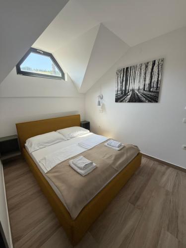 a bedroom with a large bed with a window at Otta Apartments Golte in Mozirje