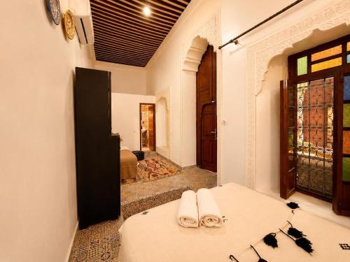 a room with a bed with towels on it at Riad Dar El Kaid in Fez