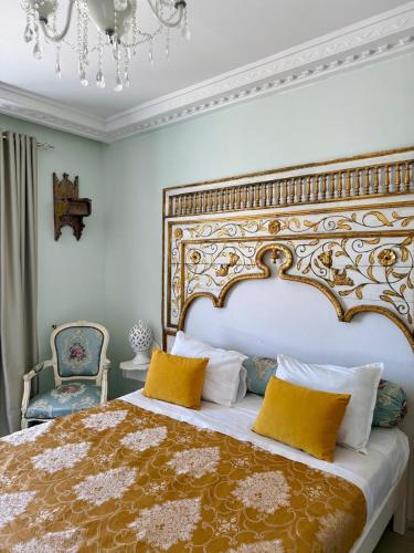 a bedroom with a large bed with yellow pillows at Dar Yessine Boutique Hôtel in Sousse