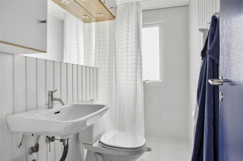 a white bathroom with a sink and a toilet at LN76217-Hjorring-Hjaelmerenden-2 in Hjørring