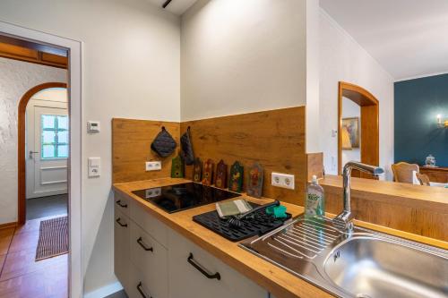 a kitchen with a sink and a stove at Schillings Häusken in Brilon