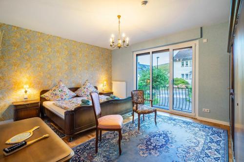 a bedroom with a bed and a desk and a window at Schillings Häusken in Brilon