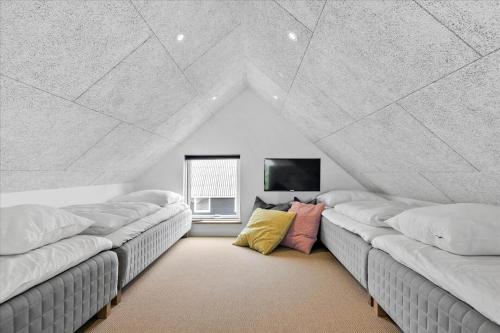 a room with three beds in a room at LN1842-Hjorring-Lobet-5 in Hjørring