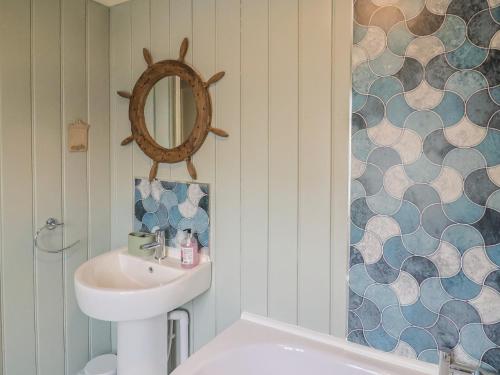 a bathroom with a sink and a mirror at 5B Bridge Street in Lyme Regis