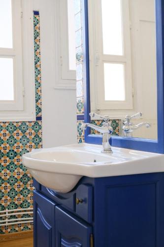 a bathroom with a white sink and blue cabinets at VILLA treize quartier balnéaire in Mers-les-Bains