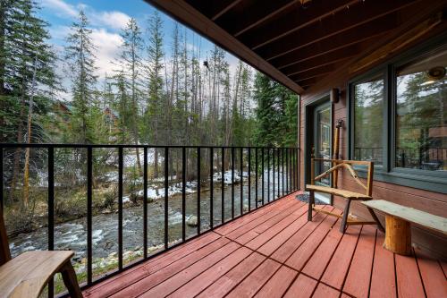 a porch with a bench and a view of a river at Winter Park Place #1 in Winter Park