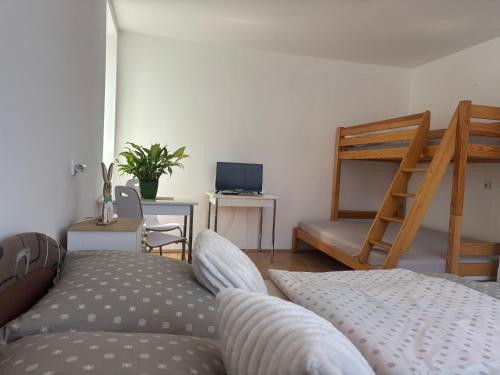 a living room with a couch and a bunk bed at Grand House in Štúrovo