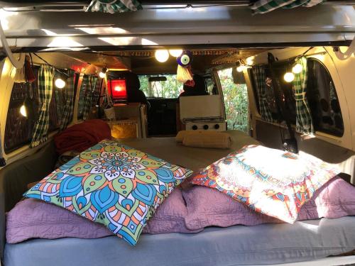 a camper van with two pillows in the back at Zíngara - Kombi Home in Brumadinho