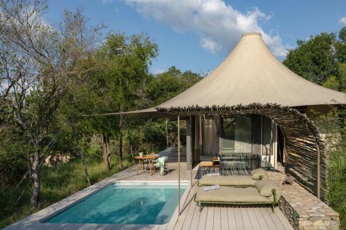a pavilion with a swimming pool and a tent at Saseka Tented Camp in Hoedspruit