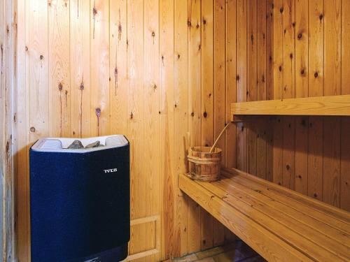 a corner of a sauna with a blue trash can at 8 person holiday home in Asnæs in Asnæs