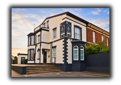 a large white building with a sign on it at Kop View Rooms in Liverpool