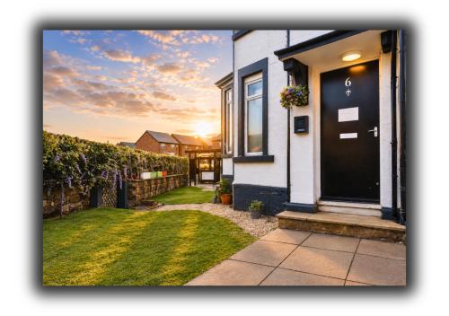 a house with a black door and a yard at Kop View Rooms in Liverpool