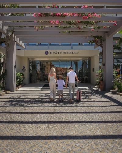 a family standing in front of a shopping center at Hyatt Regency Vilamoura Algarve in Vilamoura