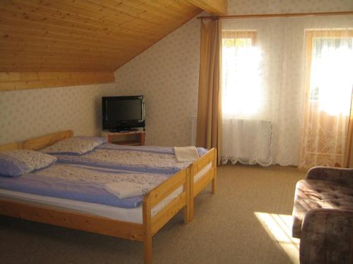 Voodi või voodid majutusasutuse Nasz Domek toas