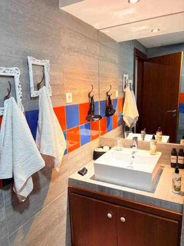 a bathroom with a sink and a mirror at CASA DO CONDE MONTIER in Paredes de Coura