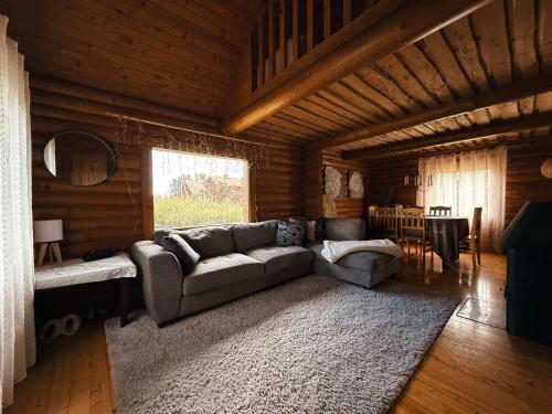 a living room with a couch and a table at Hubane palkmaja Otepää südames in Otepää