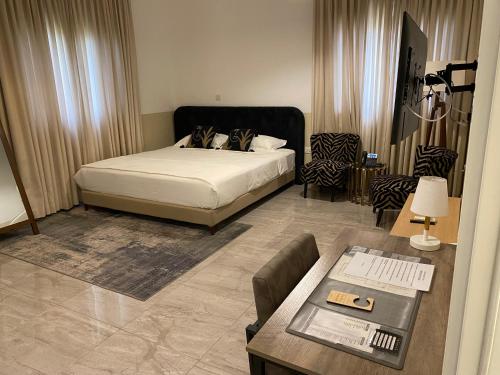 a bedroom with a bed and a living room at Casa Bianca in Accra