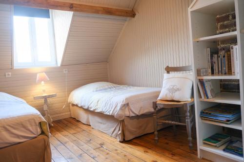 a small bedroom with a bed and a book shelf at VILLA treize quartier balnéaire in Mers-les-Bains