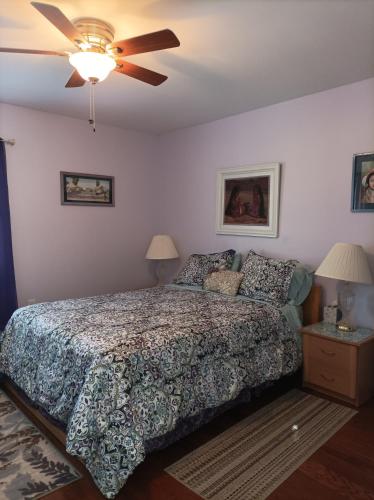 a bedroom with a bed and a ceiling fan at Cantuta Inn in Harpers Ferry