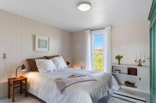 a bedroom with a large bed and a window at LN1938-Hirtshals-Kranken-9 in Hirtshals