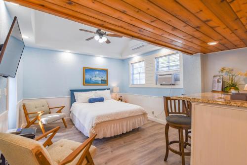 a bedroom with a bed and a desk with chairs at Welcome Matt's - Truman @ Duval Unit B in Key West