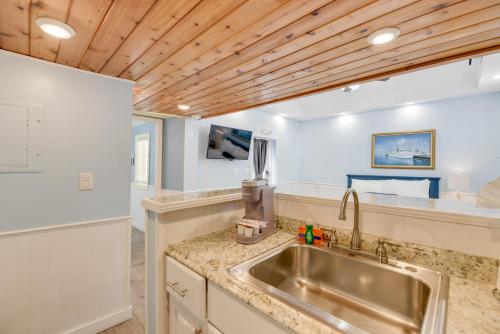 a kitchen with a sink and a wooden ceiling at Welcome Matt's - Truman @ Duval Unit B in Key West