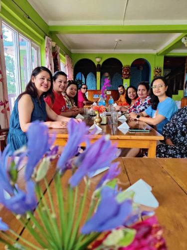 a group of people sitting at a table at Hotel Galaxy View Tower in Nagarkot