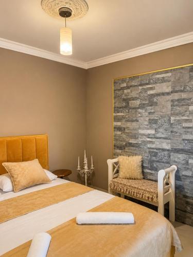 a bedroom with two beds and a stone wall at Dubai Apartment I in Veternik