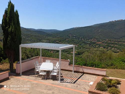 a gazebo with a table and chairs on a deck at Affittacamere Del Geco - Elba Affitti in Procchio